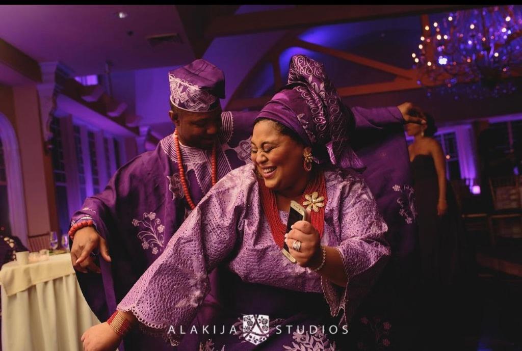 Vibrant celebration with Marien dancing in traditional purple attire